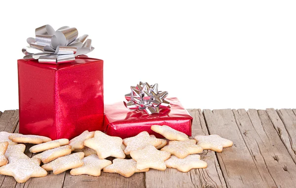 Presents and cookies on wood plank — Stock Photo, Image