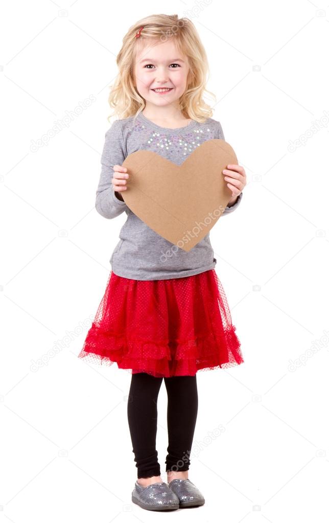 Little girl holding heart