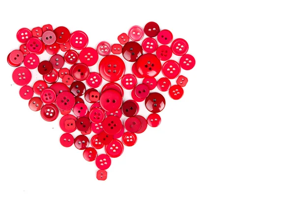 Botões vermelhos em forma de coração — Fotografia de Stock