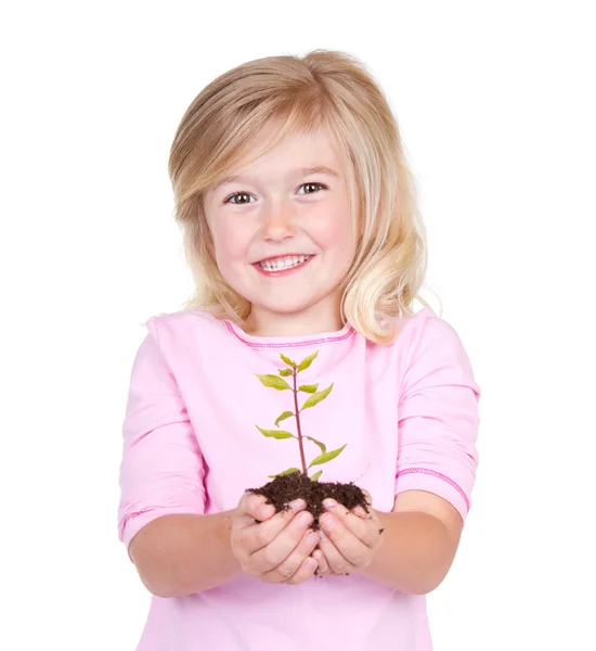 Niño sosteniendo una planta —  Fotos de Stock