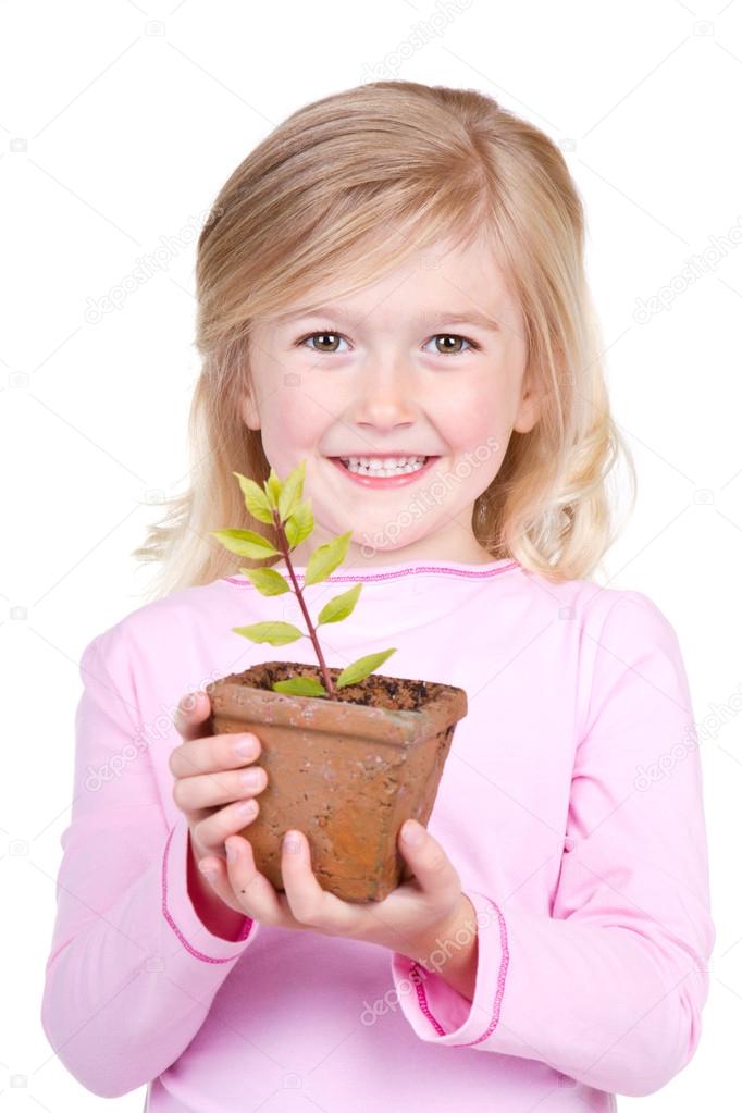 child holding a potted plant