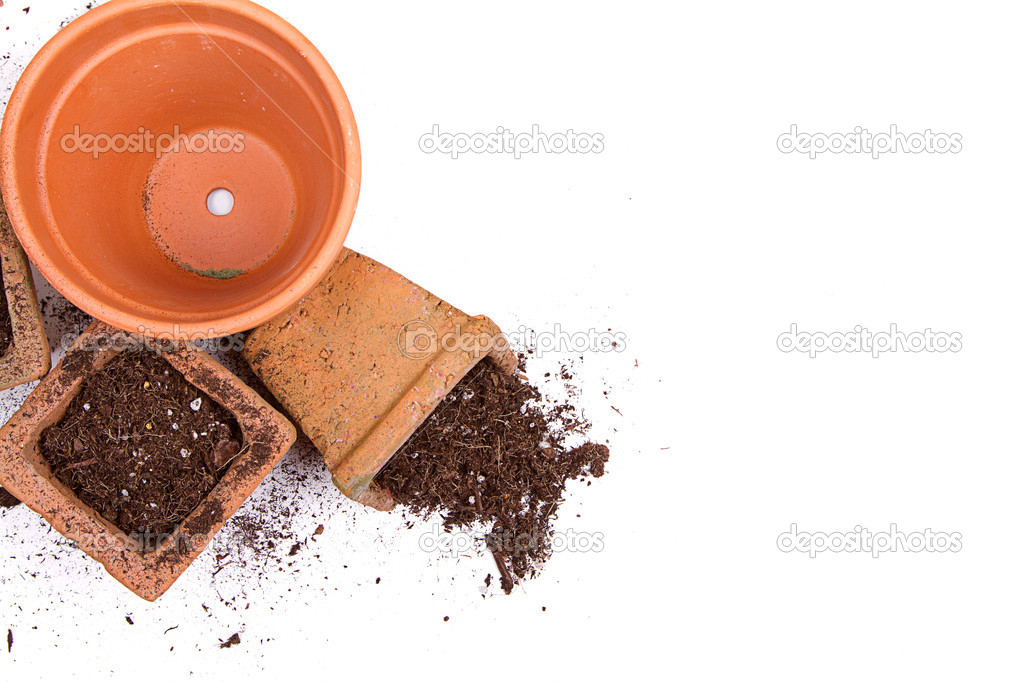 Terracotta or clay gardening pots with dirt spilling