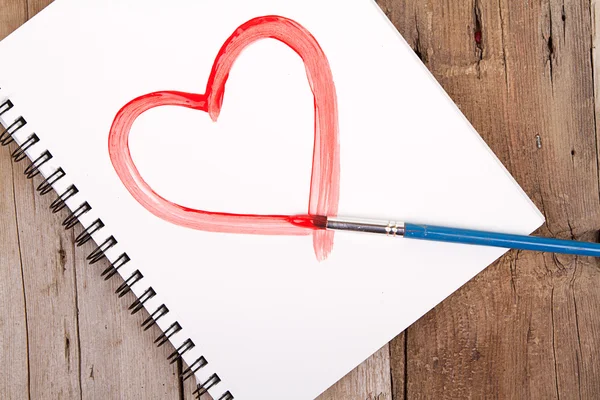 Painting of heart on notebook — Stock Photo, Image