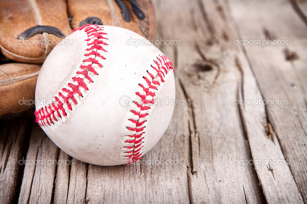baseball and mitt on wooden background