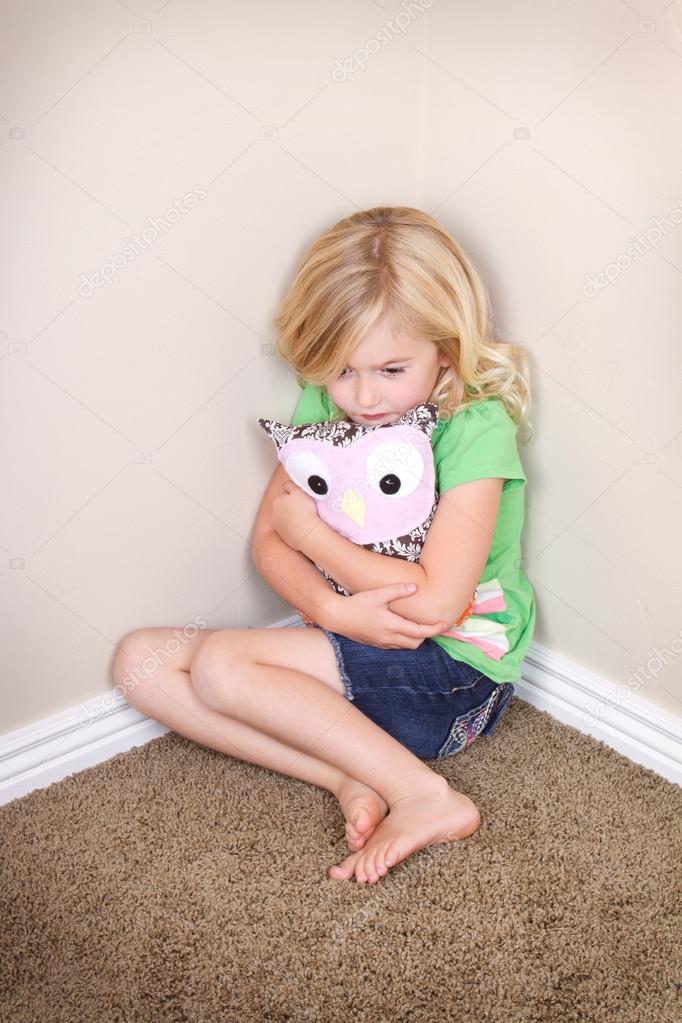 Child sitting in corner Stock Photo by ©sjhuls 28249119