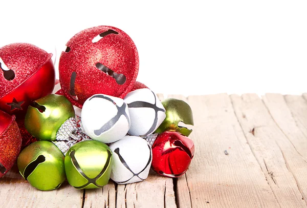 Christmas jingle bells on a plank — Stock Photo, Image