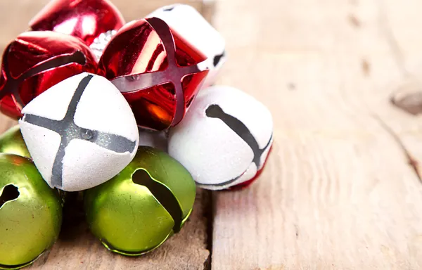 Christmas jingle bells on a plank — Stock Photo, Image