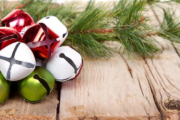 Christmas Jingle bells and a pine branch — Stock Photo, Image