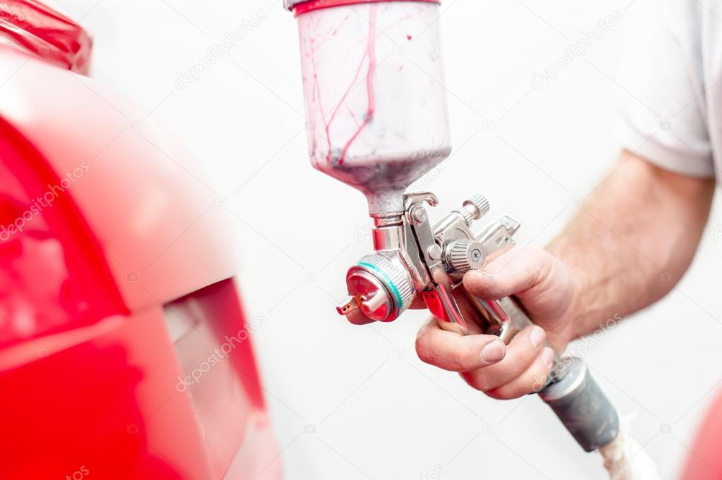 Automotive engineer working and painting on body of a car — Stock Photo