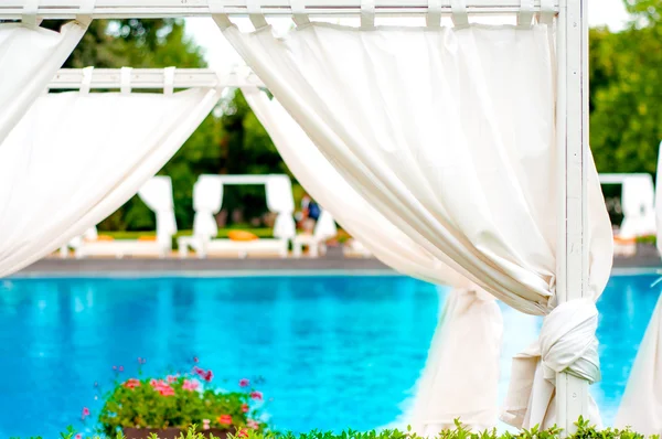 Beach front relaxing sunbeds inside tent — Stock Photo, Image