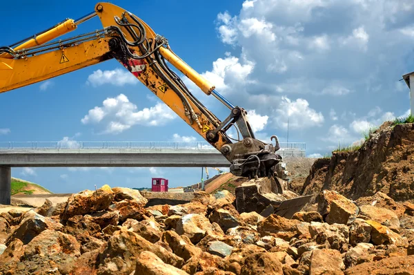 Travailleur déplacer des roches avec pelle sur le chantier de construction — Photo