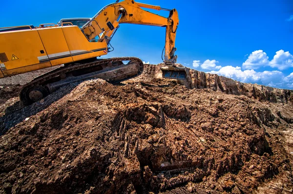 Industrial excavator working on soil material from highway — Stock Photo, Image