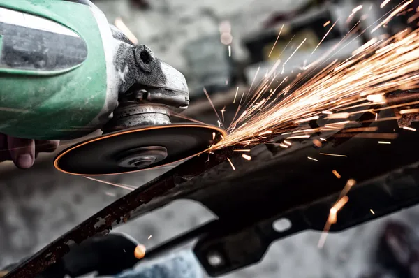Grinding through metal in steel factory — Stock Photo, Image