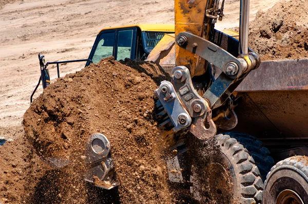 Close-up of heavy duty excavator truck loading sand Stock Picture