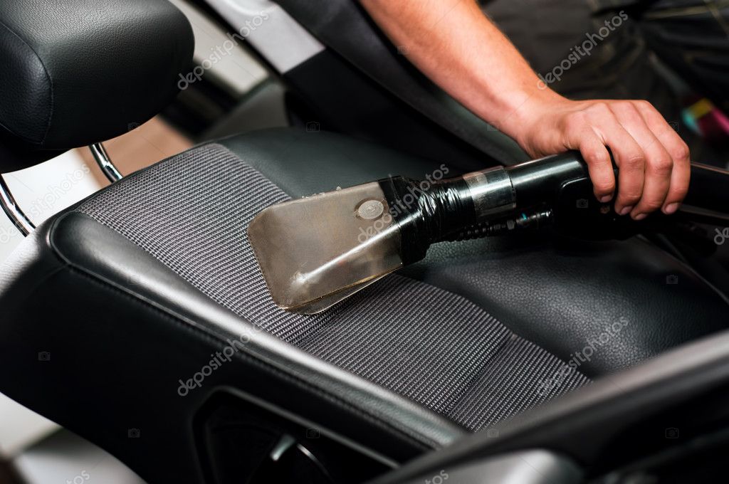 Auto car service cleaning the drivers seat, cleaning and vacuuming