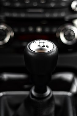 close-up of gearstick inside a car agains cockpit and dash clipart