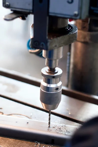 CNC industrial machine making symetrical holes into metallic bar — Stock Photo, Image