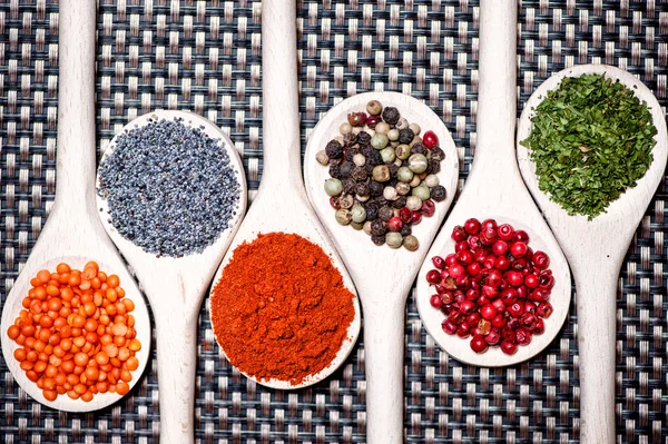 Colorful mix of assortment spices with bean seeds, poppy seeds and different types of pepper — Stock Photo, Image