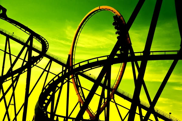 Silhouette of roller coaster against green background — Stock Photo, Image