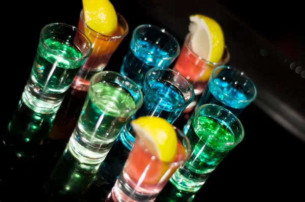 Several shots of different drinks at a party in a nightclub — Stock Photo, Image