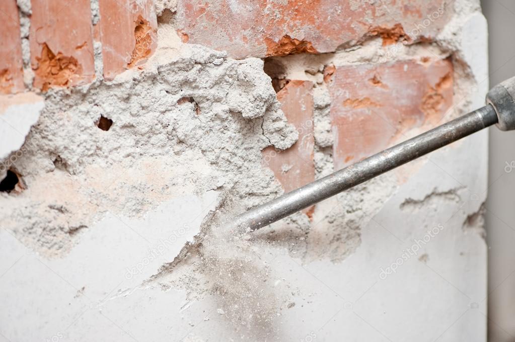 Close-up of jackhammer destroying walls