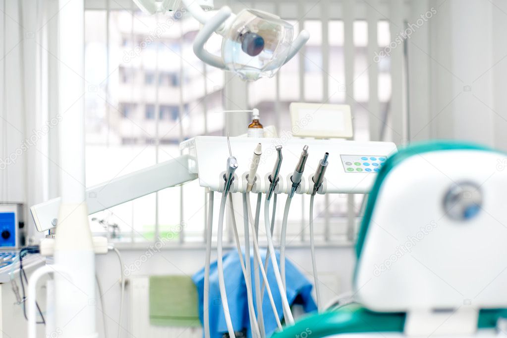 Modern dental clinic with tools, patient chair and equipment
