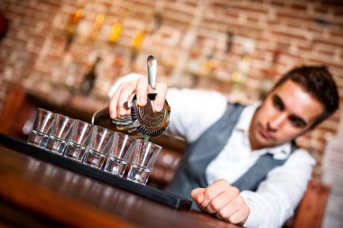 Barmen alkollü içki küçük gözlük içine dökülen açık bar