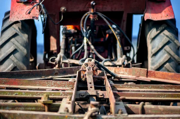 Close-up detail of tractor or machine harvesting the field — Stock Photo, Image