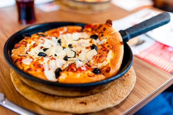 Gorące świeżej pizzy na kolację w tradycyjnej włoskiej restauracji z szynką, bekonem i serem podawane na płycie grzejnej — Zdjęcie stockowe