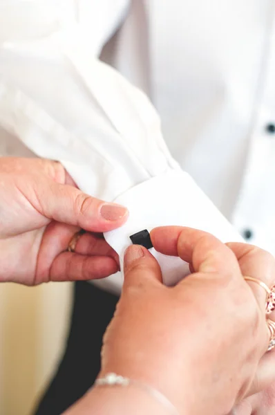 Woman hands preparing groom for wedding day. Elegant man dressing up. Detail of cufflinks and tie. Vintage effect — Stock Photo, Image