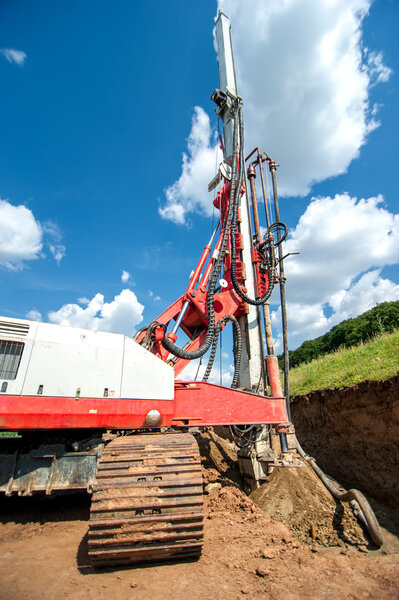 Industrial drilling rig at construction site making holes and drilling