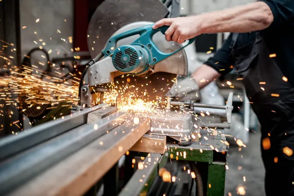 Man, worker using a sliding compound mitre saw with circular blade for cutting meta — Stock Photo, Image