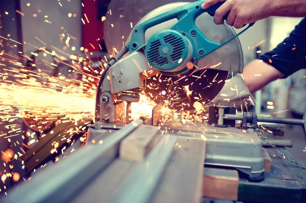 Industrial engineer working on cutting a metal and steel with compound mitre saw with sharp, circular blade — Stock Photo, Image