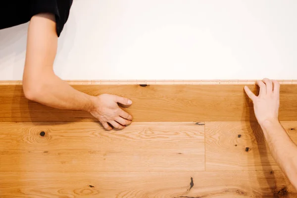 Close Worker Hands Craftsman Installing Wooden Board Hardwood Parquet — 图库照片