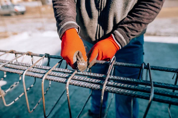 Male Construction Worker Hands Securing Steel Bars Wire Rod Reinforcement — стоковое фото