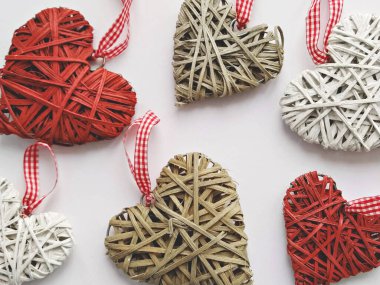 Beyaz arkaplanda el yapımı hasır kalpler, üst görünüm