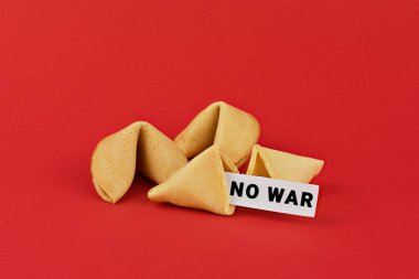 Chinese fortune cookies on red background with inscription NO WAR. Call for peace and an end to the war