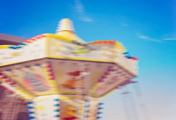 Colored Childrens Carousel Motion Blur Blue Sky Fun Fair — Fotografie, imagine de stoc