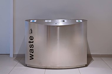 Modern steel litter bin with sections for sorting rubbish in public place inside, nobody