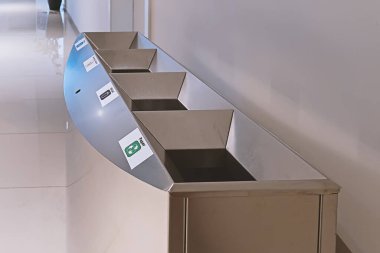 Modern steel litter bin with sections for sorting rubbish in public place inside, nobody