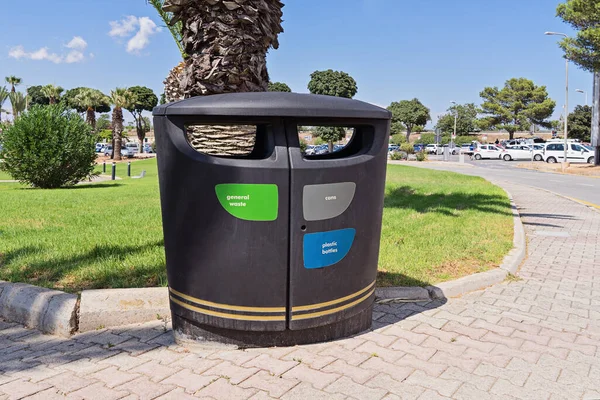 Modern litter bin with sections for sorting rubbish in public place outdoor, nobody