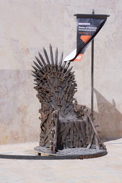 Iron Throne from series Game of Thrones on streets of Valleta, Malta and a crowd of fans who want to take pictures: Valletta, Malta - April 6, 2019