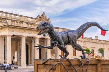 Statue of Blue Velociraptor who starred in recent film, Jurassic World Dominion which was filmed partially on location in Malta, now placed on Valletta for tourist: Valletta, Malta - August 31, 2022