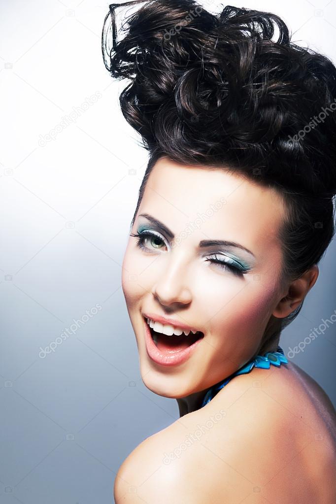 Portrait of beautiful young laughing shopper woman