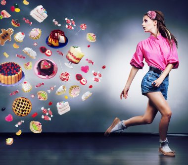 Escape. Resolute running woman refuses to eating tasty cakes and chocolate. Diet concept