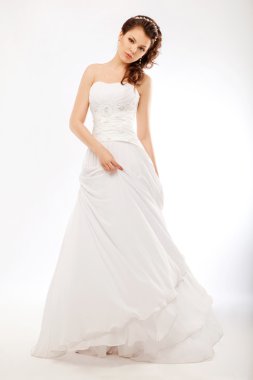 Beautiful bride in luxurious white wedding long dress posing clipart