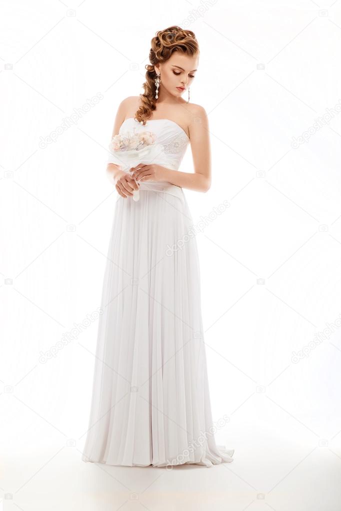 Beauty newlywed woman with wedding bouquet of flowers