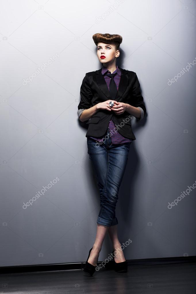 Pinup girl in american retro style in vintage tie, shirt, jacket