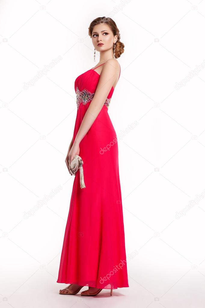 Fashion young woman in luxury red long dress with handbag
