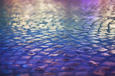 Cobble Stone Pavement - Reflexion in Urban Night. Wet Blue Sidewalk